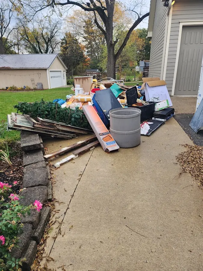 Dumpster being loaded with debris for Estate Cleanout Dumpster Rental in Portland